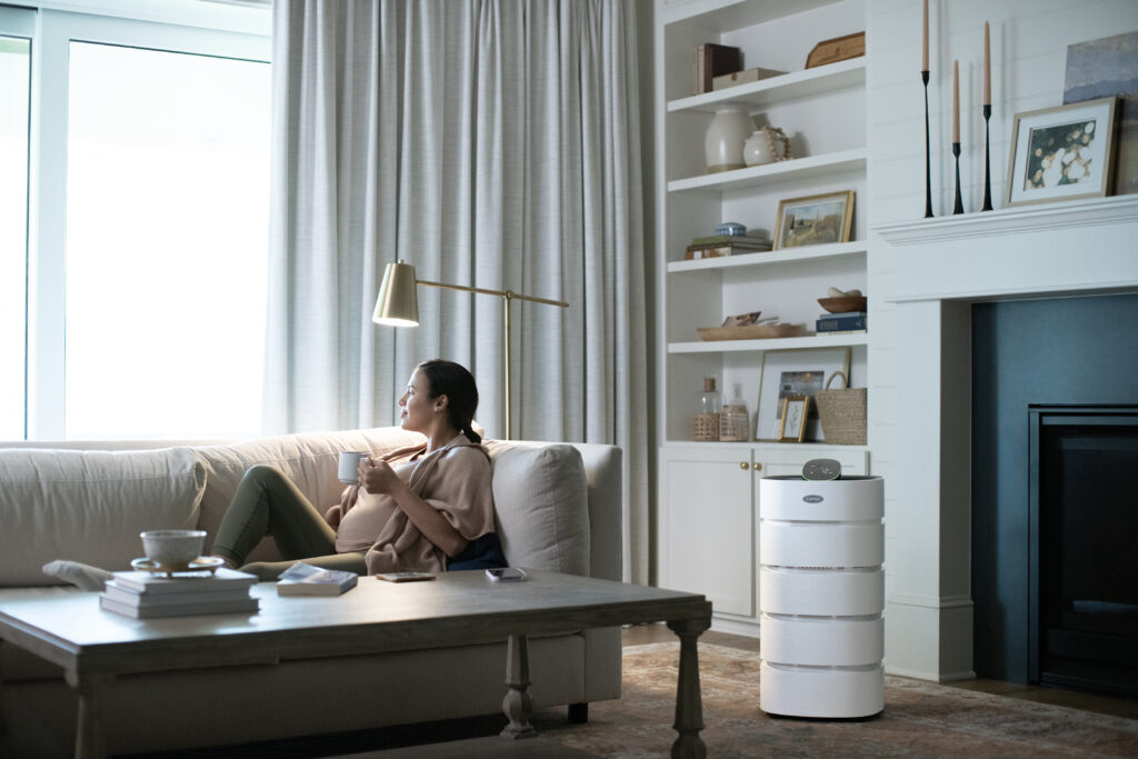 woman on couch next to air purifier